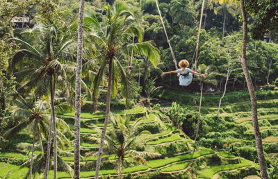 Rear view of woman on a swing 