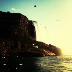 Scenic view of sea with mountain range in background
