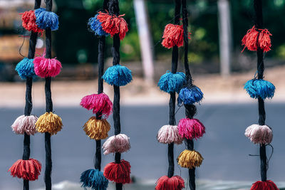 Close-up of colorful decors hanging at market stall