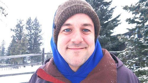 Portrait of smiling man in snow