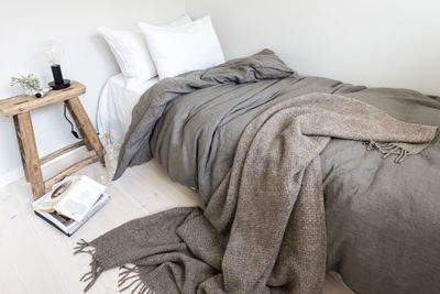 High angle view of duvet and rug on bed at home