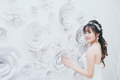Bride standing against wall