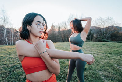 Portrait of young woman exercising in park