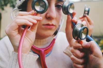 Close-up portrait of woman holding camera