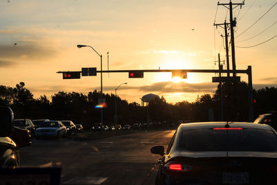 Cars on road at sunset
