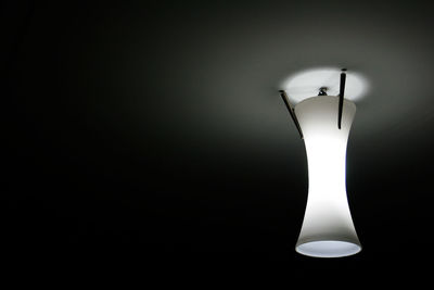 Low angle view of illuminated lamp on ceiling