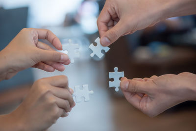 Cropped image of people holding hands