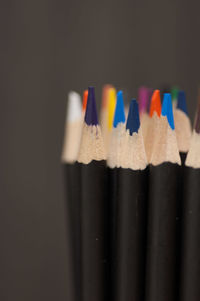 Close-up of multi colored pencils over black background