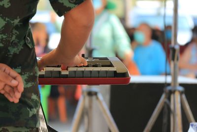 Midsection of man playing piano