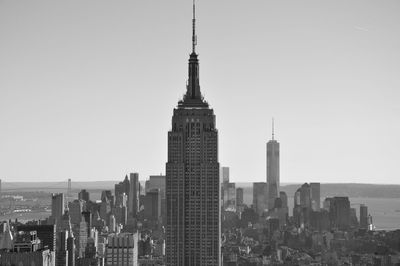 Modern buildings in city against clear sky