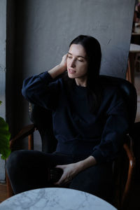 Woman sitting on chair at cafe