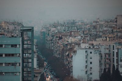 Buildings in city against sky at dusk