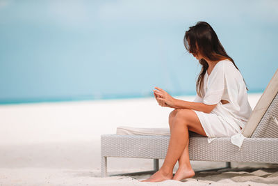 Woman sitting on beach