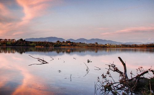 Scenic view of lake against sky at sunset