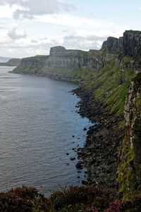 Scenic view of sea and mountains against sky