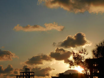 Low angle view of silhouette trees against sky