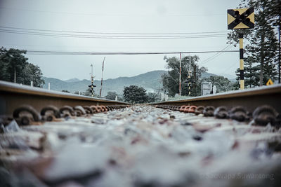 Surface level of railroad tracks against sky