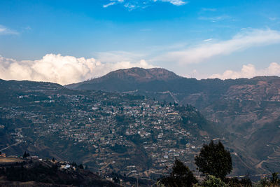 City urbanization view from hilltop with huge construction and dramatic sky