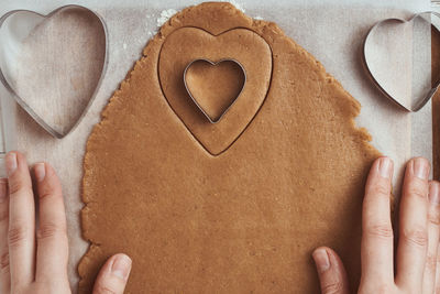 Midsection of woman holding heart shape cookies