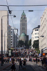 Group of people walking on road in city