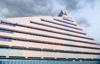 Modern building against cloudy sky