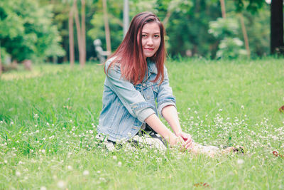 Portrait of smiling young woman on field