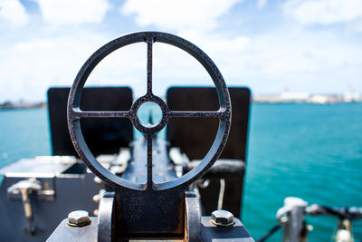 Close-up of metal ship against sea