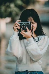 Portrait of woman photographing