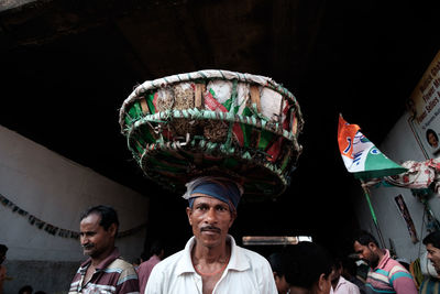 Portrait of people standing against built structure