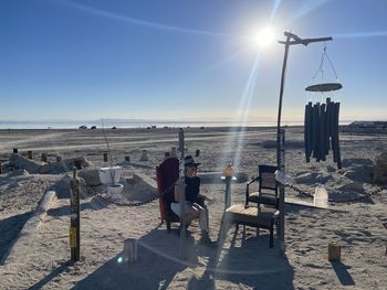 People on beach against sky