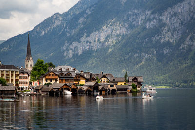 Buildings by lake and mountains