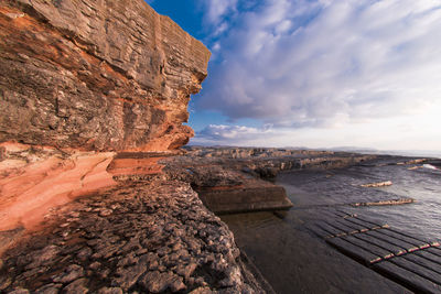 Scenic view of sea against cloudy sky