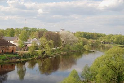 Scenic view of lake by buildings against sky