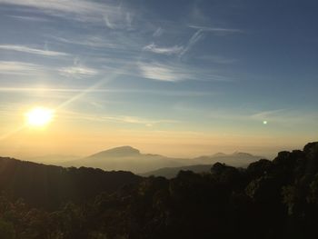 Scenic view of silhouette mountains against sky at sunset