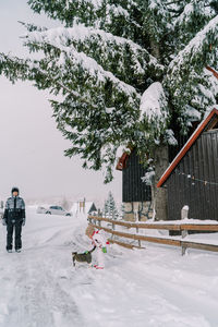 People skiing on snow covered field