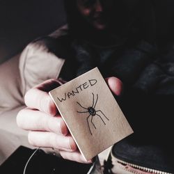 Close-up of hand holding text