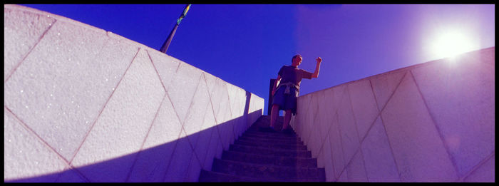 Low angle view of woman walking on steps