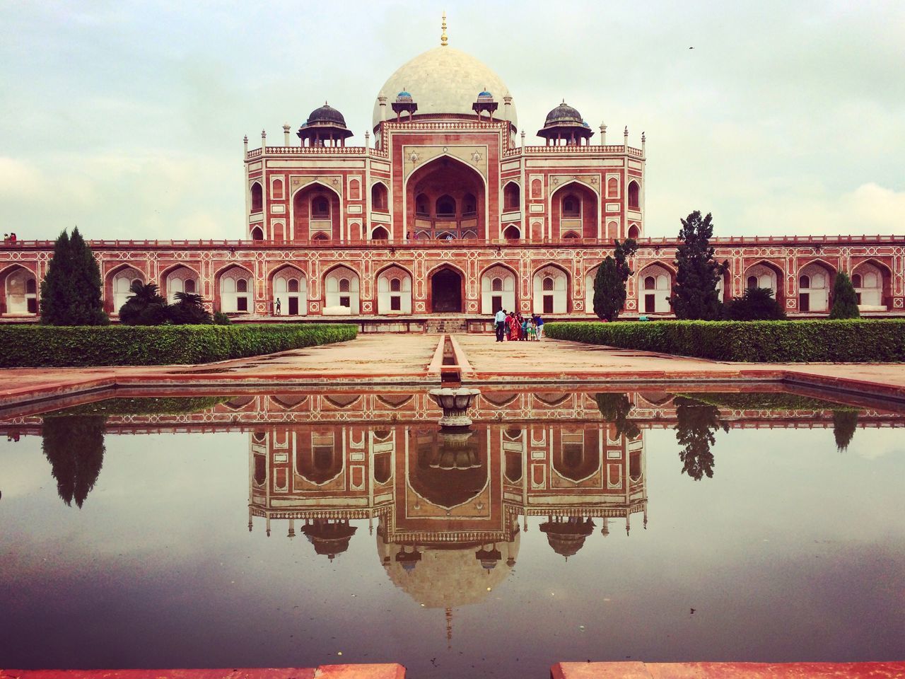 reflection, architecture, built structure, building exterior, sky, waterfront, travel destinations, water, symmetry, dome, standing water, city, outdoors, tree, no people, day