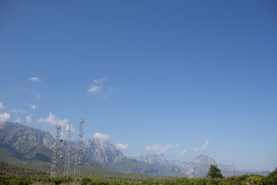 Scenic view of mountains against blue sky