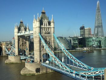 Low angle view of bridge and buildings against sky