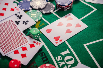 High angle view of gambling chips and cards on table