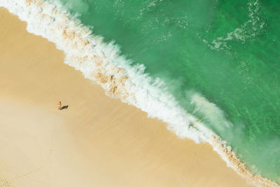 Aerial view of woman standing on beach