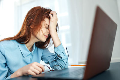 Tired woman sitting at office