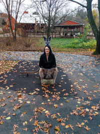 Portrait of woman sitting in kangaroo structure