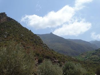 Scenic view of mountains against cloudy sky