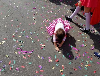 Cheerful girl playing outdoors with confetti