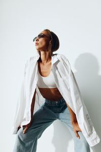 Young woman standing against white background