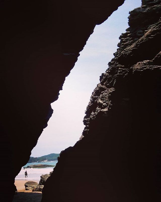 sea, silhouette, water, sky, tranquility, nature, tranquil scene, rock - object, rock formation, scenics, built structure, beach, beauty in nature, sunlight, architecture, horizon over water, mountain, day, outdoors