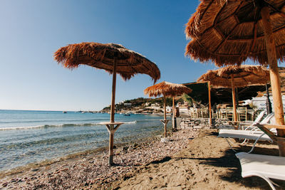 Gazebo on beach by sea against sky