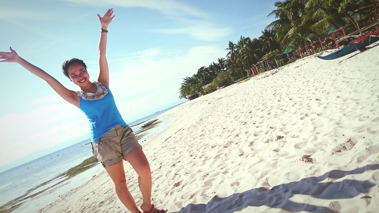 lifestyles, full length, leisure activity, casual clothing, beach, sky, person, young adult, standing, sea, sand, holding, water, shore, young women, tree, childhood, day